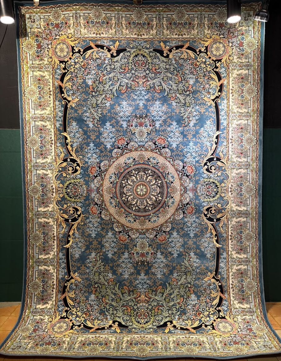 Machine-made carpet, steel blue field with round baroque medallion and scrollwork corners