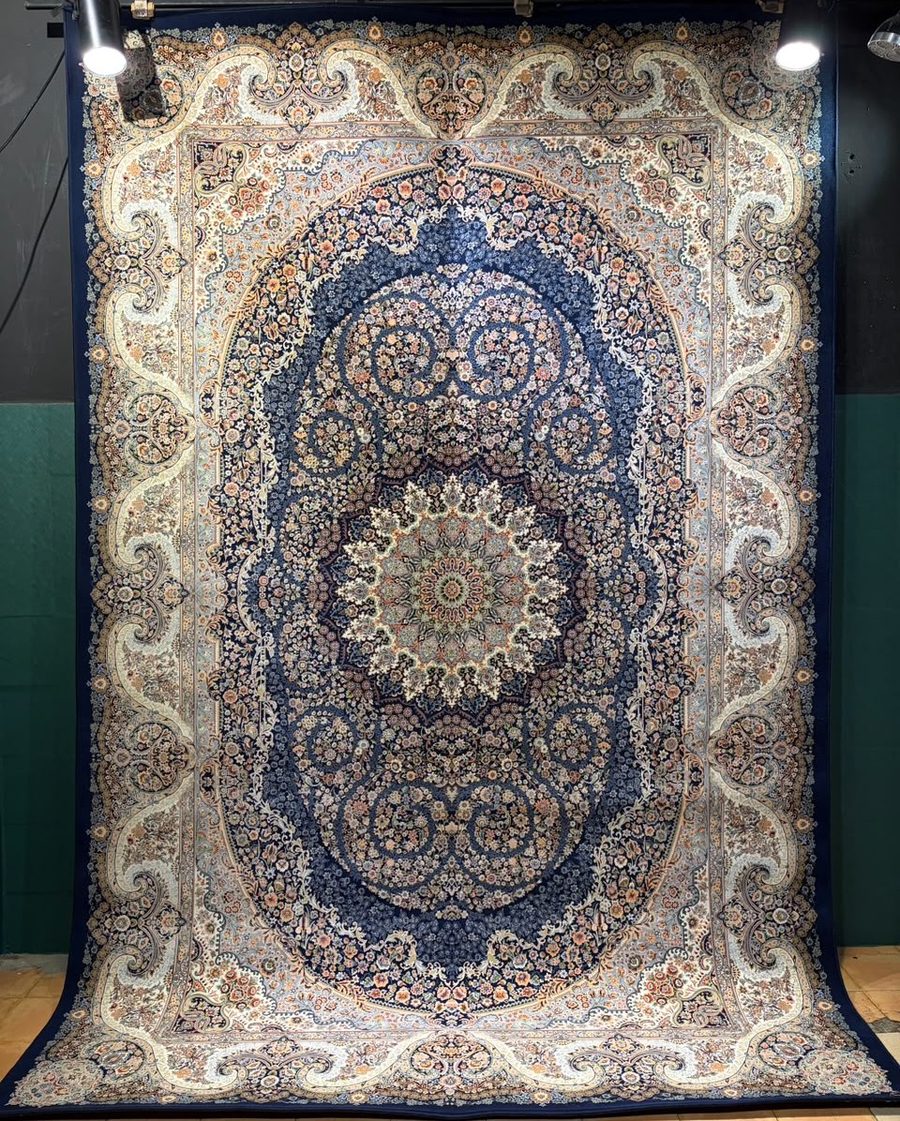 Machine-made carpet, navy field with oval rosette medallion border