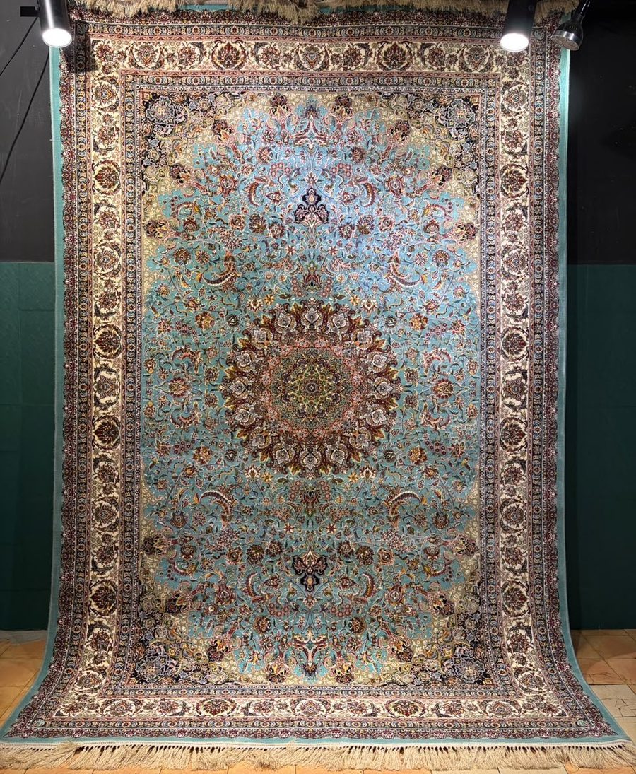 Machine-made carpet, turquoise field with round sunburst medallion